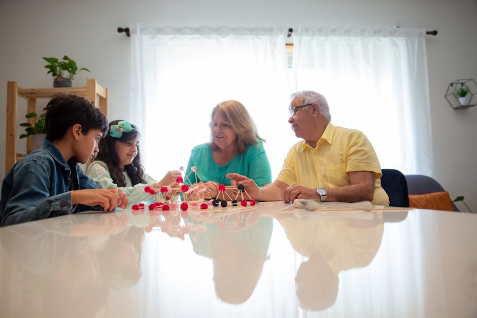 A photo of a group of people building structures with jelly beans and toothpicks at a table