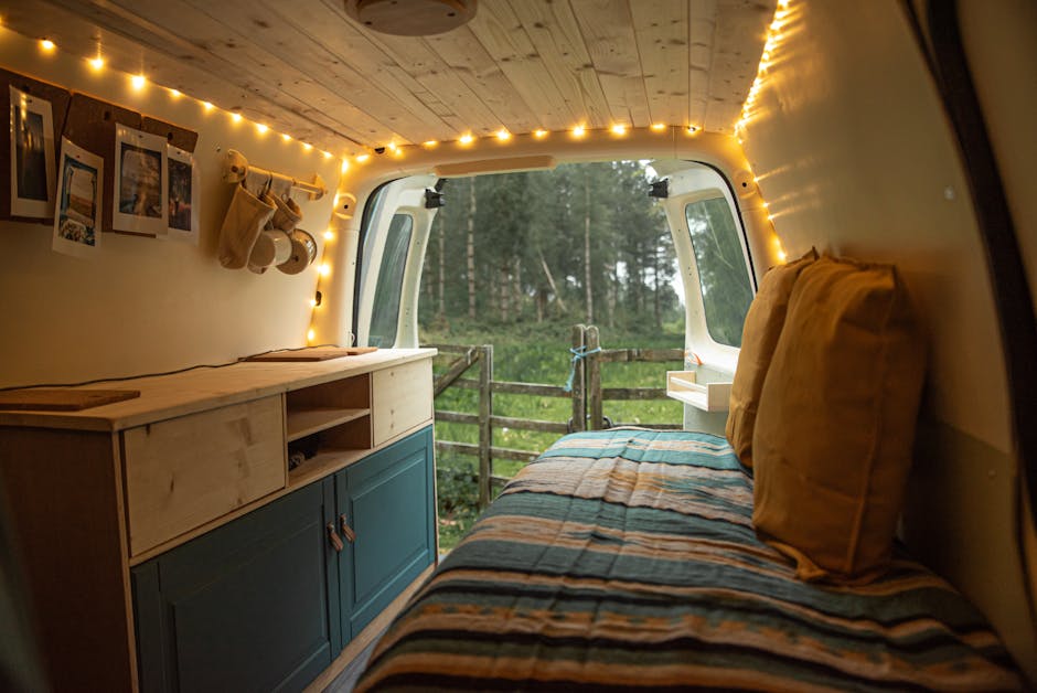 An image of a well-organized and cozy RV interior with dual-purpose furniture, vertical storage solutions, and ample lighting