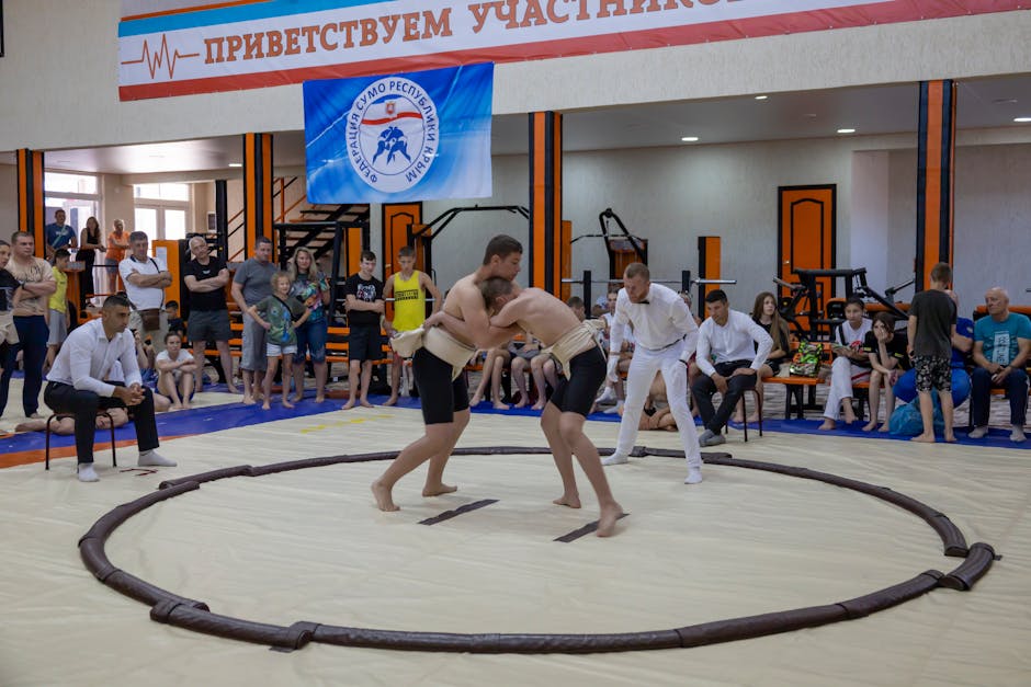 A wrestling ring with wrestlers showcasing various wrestling moves in action