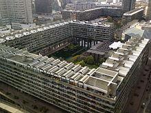 The Barbican Estate, a brutalist complex in London featuring tower blocks, an arts centre, and public spaces, exemplifying the city's post-war architectural revival.