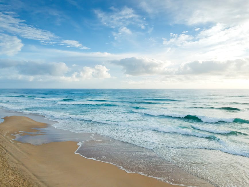 A beautiful beach scene with golden sands and clear blue waters in Alicante, Spain