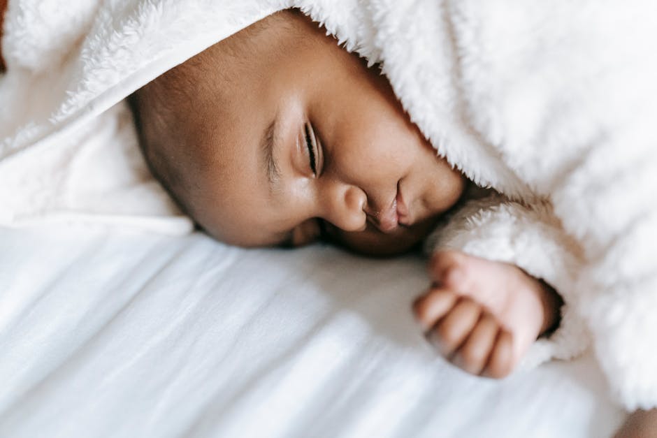 A realistic image showing children of different ages sleeping peacefully in their beds