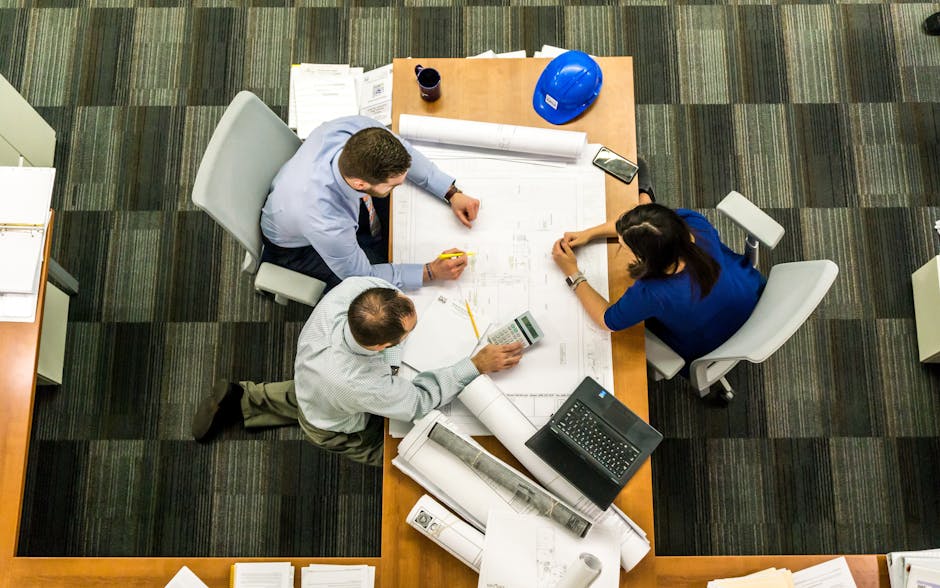 A well-crafted construction business plan document next to a hard hat and construction tools, symbolizing the foundational role of the plan in a California construction company's success