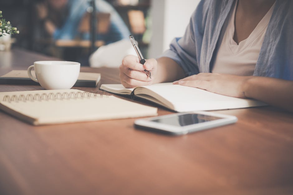 A professional setting with a person writing a cover letter at a desk with a laptop and a cup of coffee