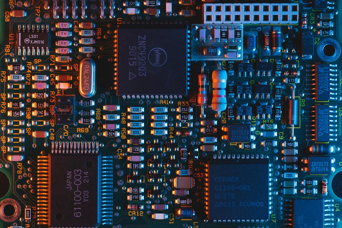 Conceptual image showing a thermometer with a computer chip to represent checking CPU temperature. The background is a cool-colored futuristic digital environment.