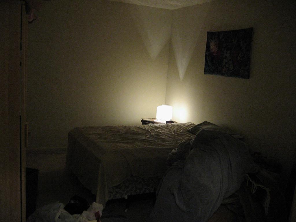 A dark bedroom with blackout curtains drawn