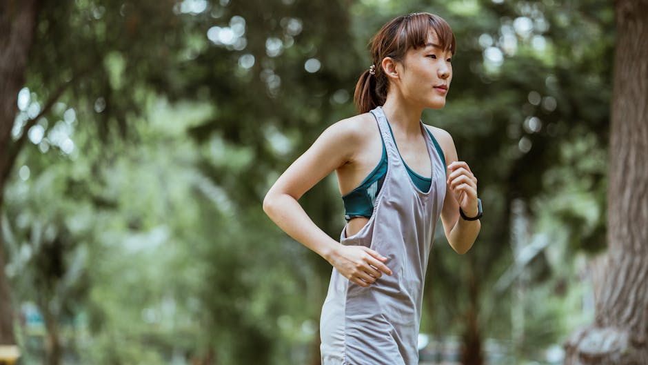 A person jogging outdoors in nature, looking determined and focused.