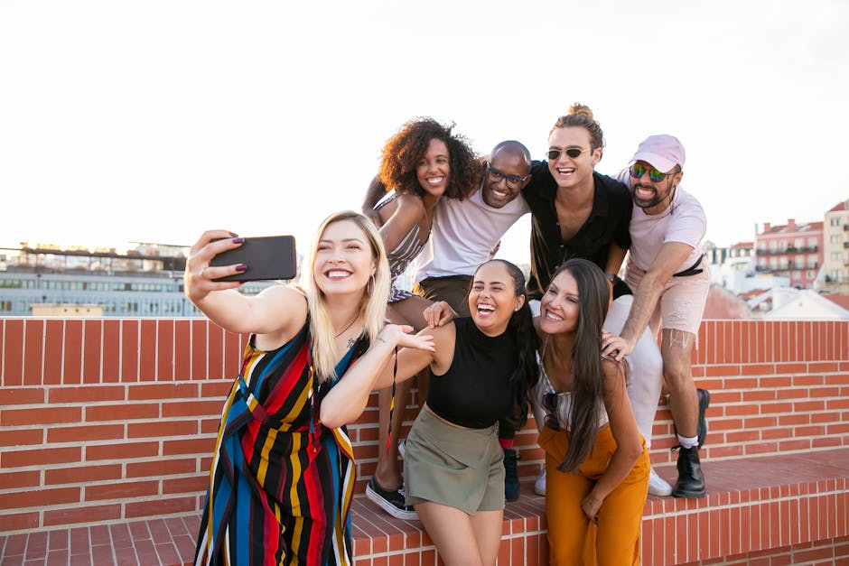 A diverse group of people smiling and talking together after a group fitness class or exercise session.