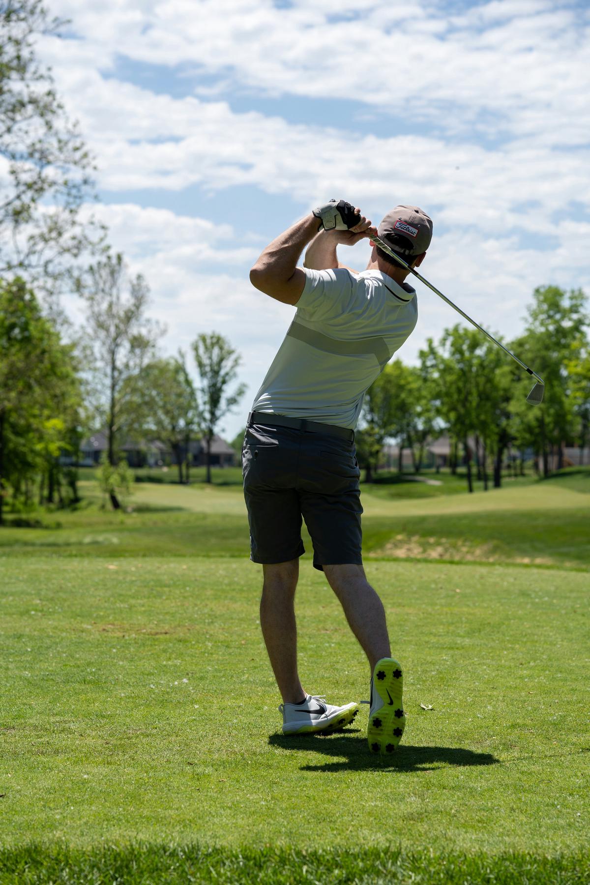 A dedicated golfer practices alone on the course, using solo practice games to refine their skills and experiment with new techniques.