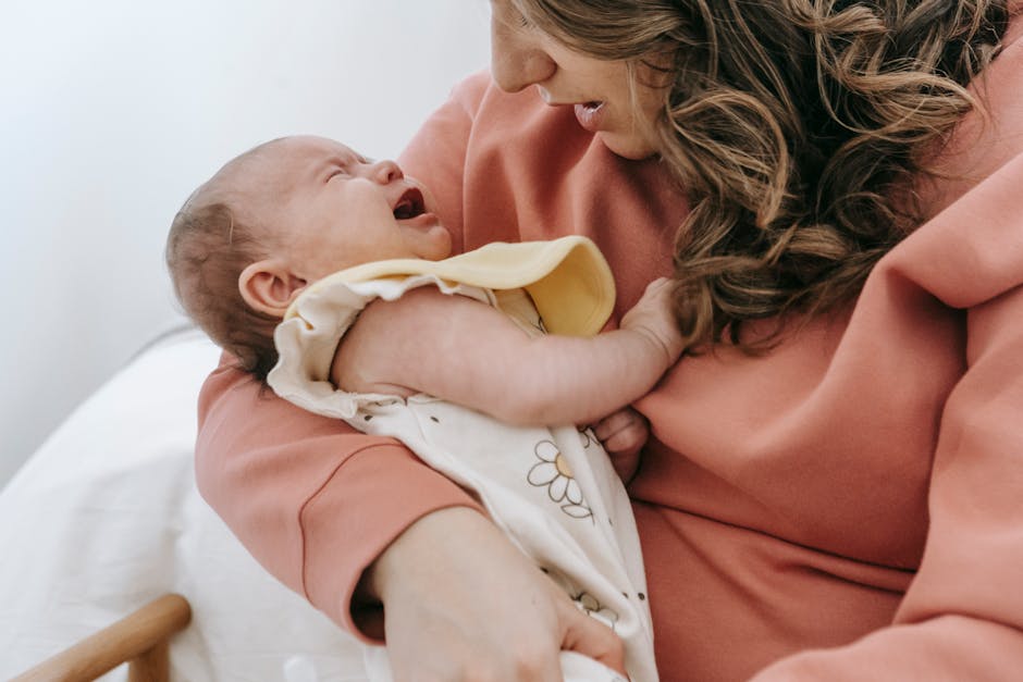 A parent gently nurturing and comforting a baby experiencing sleep challenges in a nursery.