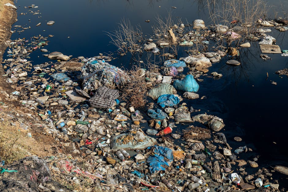 A polluted river filled with plastic waste and other debris, highlighting the environmental impact of human activities.