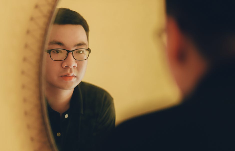 Image of a person standing in front of a mirror, symbolizing self-rediscovery and personal growth.