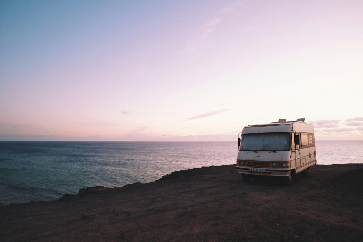 An image showing a person reading an owner's manual while working on an RV maintenance task