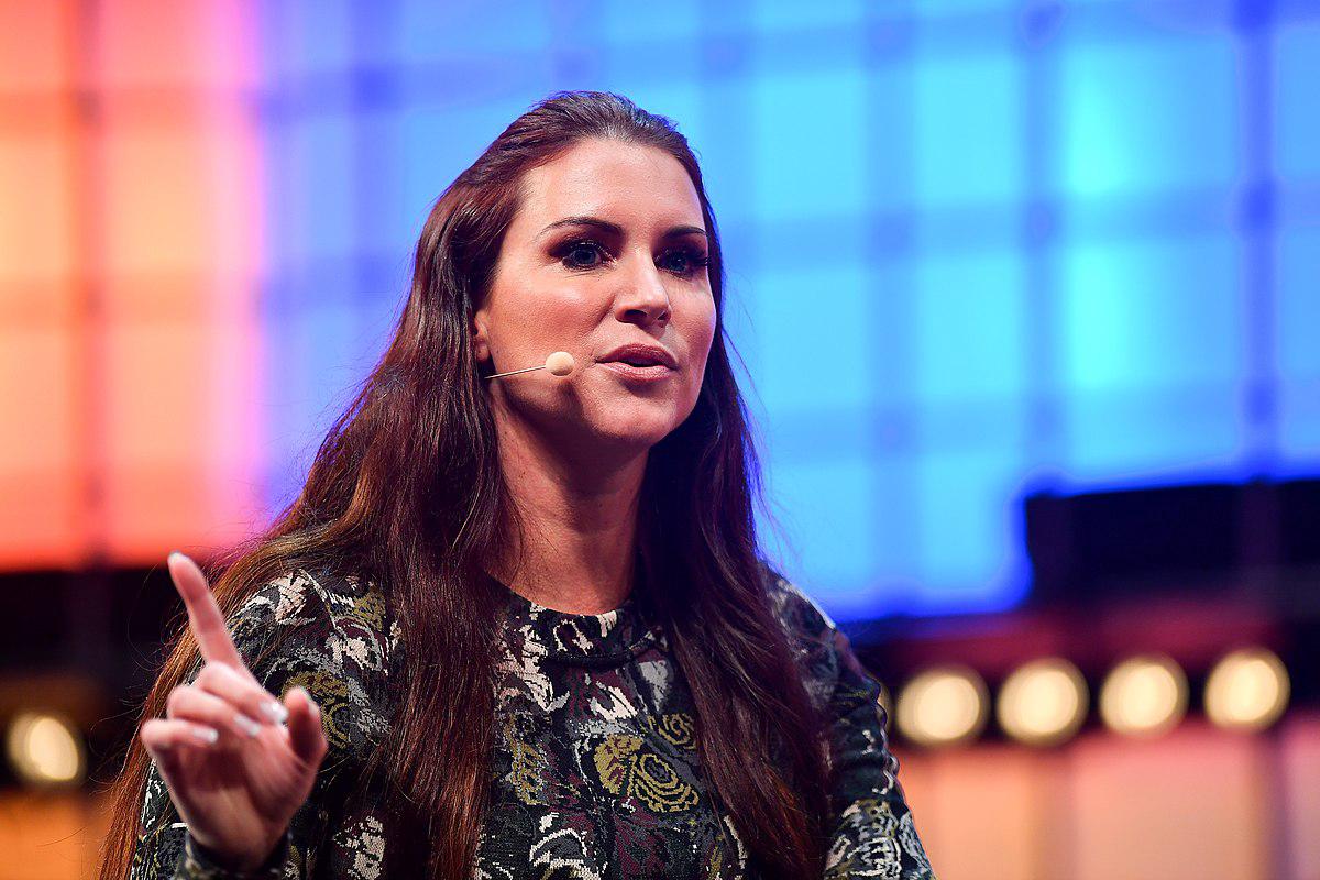 Stephanie McMahon leading a business meeting with WWE executives and creative team members