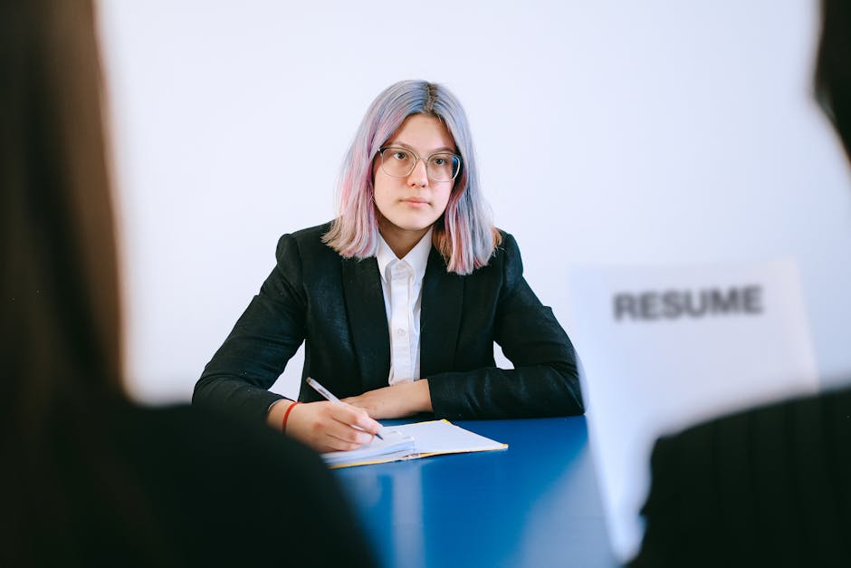 A college student receiving constructive feedback on their resume from a career advisor or professional.