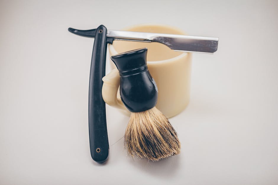 An image depicting a traditional wet shaving set with a razor, brush, and soap