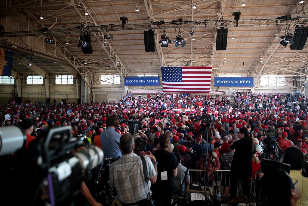 Passionate Donald Trump supporters at a campaign rally holding signs and cheering