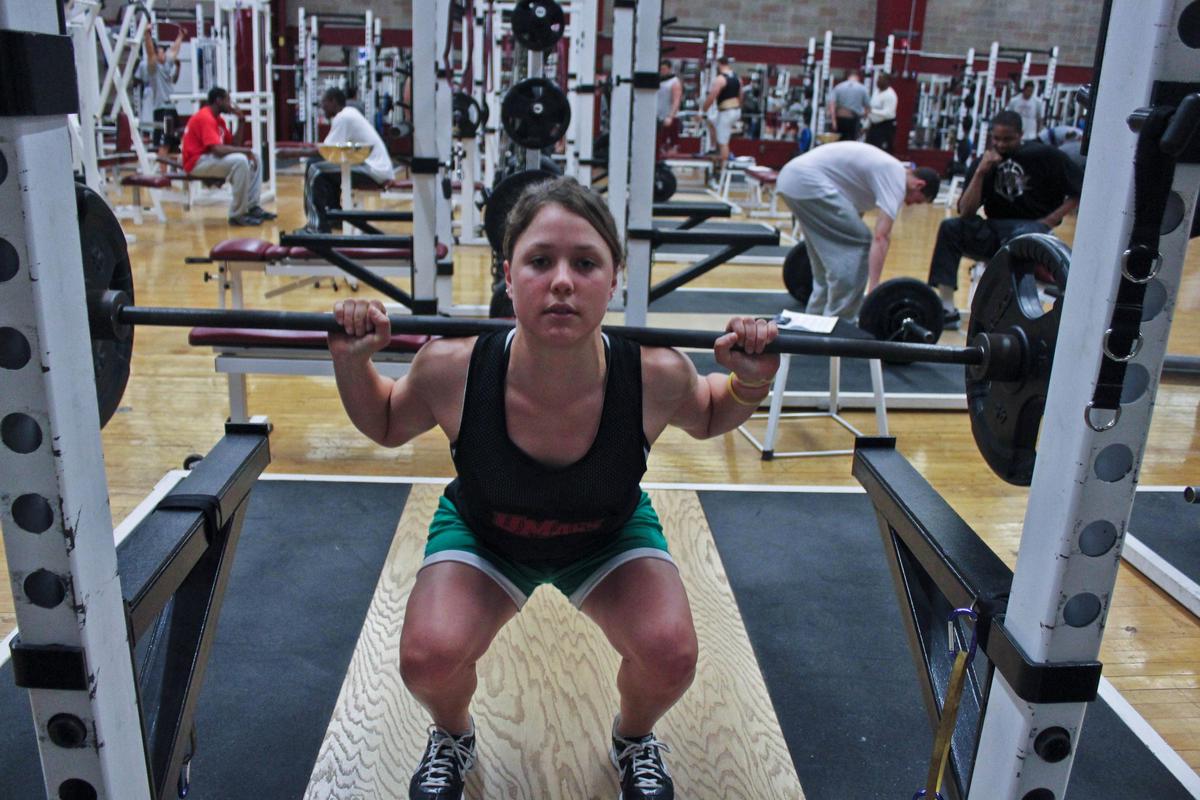 A weightlifter perfecting their squat form, demonstrating proper technique and alignment