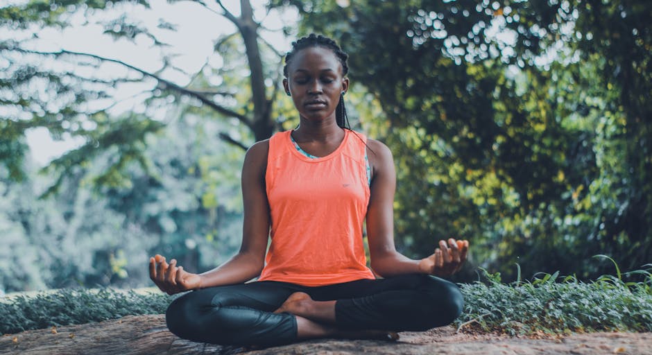 A person practicing yoga in a peaceful outdoor setting, looking calm and focused.